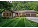 Charming home with manicured lawn, a welcoming front porch, and an attached two-car garage at 14027 Springwater Dr, Matthews, NC 28105