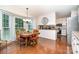Bright kitchen and dining area with large bay windows, hardwood floors and white cabinetry at 14027 Springwater Dr, Matthews, NC 28105