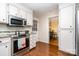View of the kitchen featuring stainless steel appliances and a view of the living room at 14027 Springwater Dr, Matthews, NC 28105