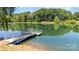 Scenic lake with a private dock, offering a serene waterfront setting for outdoor enjoyment and relaxation at 14027 Springwater Dr, Matthews, NC 28105