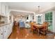 Open concept living space featuring hardwood floors, with dining, kitchen, and living room areas visible at 14027 Springwater Dr, Matthews, NC 28105