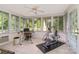Bright sunroom with lots of natural light and a ceiling fan, a great flex space for exercising or an office at 14027 Springwater Dr, Matthews, NC 28105