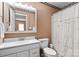 Cozy bathroom with a white vanity, toilet, and shower with a decorative curtain at 147 Bluewing Ln # 274, Mooresville, NC 28117