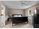 Cozy bedroom with a black sleigh bed, neutral walls, and plush carpet at 147 Bluewing Ln # 274, Mooresville, NC 28117