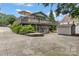 Two-story home with a large deck, garage doors, and a well-maintained yard at 147 Bluewing Ln # 274, Mooresville, NC 28117