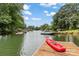 Beautiful waterfront view featuring a dock, boat, kayak, and lush greenery at 147 Bluewing Ln # 274, Mooresville, NC 28117