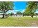 Expansive backyard view with lush greenery and mature trees, showcasing the home's serene setting at 1501 E Church St, Cherryville, NC 28021
