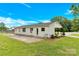 Exterior view of the rear of the home with a large concrete patio and lush green lawn at 1501 E Church St, Cherryville, NC 28021