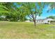 A spacious backyard with lush lawn and mature trees surrounding a well-kept home at 1501 E Church St, Cherryville, NC 28021