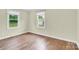 Bright bedroom with hardwood floors, two windows, and neutral paint, offering a cozy and inviting space at 1501 E Church St, Cherryville, NC 28021