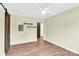 Spacious neutral bedroom featuring hardwood floors, access to other rooms and a sliding barn door at 1501 E Church St, Cherryville, NC 28021