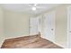 Bedroom with wood-look flooring, featuring white trim, doors, and ceiling fan at 1501 E Church St, Cherryville, NC 28021