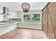 Bright dining area featuring hardwood floors, modern lighting and a sliding barn door at 1501 E Church St, Cherryville, NC 28021