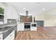 Bright renovated kitchen featuring stainless appliances, a farmhouse sink, and pendant lighting at 1501 E Church St, Cherryville, NC 28021