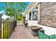 Charming front porch has decorative wood toned shutters, potted plants and wood railing at 1501 E Church St, Cherryville, NC 28021