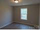 Bright bedroom featuring wood-look flooring, fresh paint, and a window providing natural light at 153 Mason Tanner Ct, Rock Hill, SC 29730