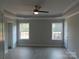 Spacious room boasts fresh paint, recessed ceiling, two large windows, and modern ceiling fan at 153 Mason Tanner Ct, Rock Hill, SC 29730