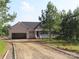 Charming single-Gathering home featuring a covered front porch and an attached two-car garage with gravel driveway at 153 Mason Tanner Ct, Rock Hill, SC 29730