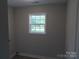 A small, gray room with white trim window and baseboards is freshly painted and has wood-look flooring at 153 Mason Tanner Ct, Rock Hill, SC 29730