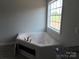 Bathroom features a garden tub near a bright window at 153 Mason Tanner Ct, Rock Hill, SC 29730