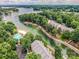 Stunning aerial view featuring lakefront condos, a pool, boat docks and lush landscaping at 19901 Henderson Rd # M, Cornelius, NC 28031