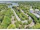 Aerial view of the community showing the lake, townhomes, and lush landscaping at 19901 Henderson Rd # M, Cornelius, NC 28031