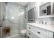 Bathroom featuring a vanity, toilet, and glass door shower with marble-style tiles at 19901 Henderson Rd # M, Cornelius, NC 28031