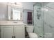 Bathroom featuring a vanity, toilet, and glass door shower with marble-style tiles at 19901 Henderson Rd # M, Cornelius, NC 28031