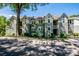 Exterior view of a two-story condominium building with light green siding, white trim and dormer windows at 19901 Henderson Rd # M, Cornelius, NC 28031