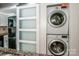 Laundry area featuring a stackable washer and dryer next to the kitchen at 19901 Henderson Rd # M, Cornelius, NC 28031
