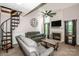Comfortable living room with a fireplace, spiral staircase, and natural light at 19901 Henderson Rd # M, Cornelius, NC 28031