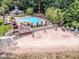 Aerial view of pool and deck area by the lake, surrounded by mature trees and landscaping at 19901 Henderson Rd # M, Cornelius, NC 28031