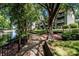 Picturesque view of a lakefront walkway, surrounded by mature trees and waterfront condominiums at 19901 Henderson Rd # M, Cornelius, NC 28031