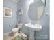 Stylish half bathroom featuring a pedestal sink, and neutral wall color at 2017 White Cedar Ln, Waxhaw, NC 28173