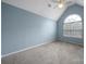 This bedroom boasts a charming arched window and neutral carpet and paint at 2017 White Cedar Ln, Waxhaw, NC 28173