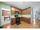 Well-equipped kitchen with hardwood floors, plenty of cabinets, and modern appliances, with dining area view at 2017 White Cedar Ln, Waxhaw, NC 28173