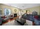 Comfortable living room featuring a fireplace, hardwood floors, and views into the kitchen at 2017 White Cedar Ln, Waxhaw, NC 28173