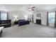 Large main bedroom with a fireplace, ceiling fan, and plenty of natural light at 2017 White Cedar Ln, Waxhaw, NC 28173