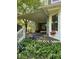 Exterior view of a partially cluttered back porch area, with overgrown plants at 208 E Main St, Cleveland, NC 27013