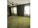 This bedroom features plush green carpet, two windows, and a closet for ample storage space at 208 E Main St, Cleveland, NC 27013