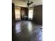 Bedroom features original dark-stained hardwood floors, wood-paneled walls and bright natural light at 208 E Main St, Cleveland, NC 27013