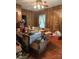 The dining room showcases a table set for a meal, with hardwood floors and wood panel walls at 208 E Main St, Cleveland, NC 27013