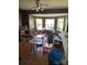 The dining room has hardwood floors, wood paneled walls, and a large set of windows at 208 E Main St, Cleveland, NC 27013