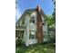 Exterior showcasing the home's design, with a prominent chimney and traditional window styles at 208 E Main St, Cleveland, NC 27013