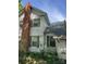 View of the side of a house with a brick chimney and multiple windows with green shutters at 208 E Main St, Cleveland, NC 27013