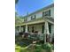 View of the side of a home featuring a covered porch and visible chimney structure at 208 E Main St, Cleveland, NC 27013