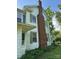 Side view of a home showcasing a brick chimney and symmetrical window arrangement at 208 E Main St, Cleveland, NC 27013