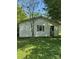 Exterior view of a detached garage featuring peeling paint at 208 E Main St, Cleveland, NC 27013
