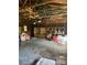 Interior of the large garage featuring exposed beams and unfinished shelving, perfect for a workshop at 208 E Main St, Cleveland, NC 27013