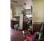 This kitchen area has wood paneling with shelving and upper and lower cabinets at 208 E Main St, Cleveland, NC 27013